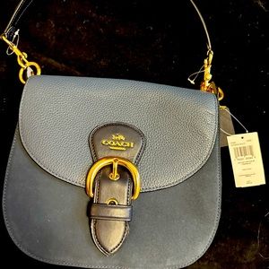 Woman’s brand new coach purse